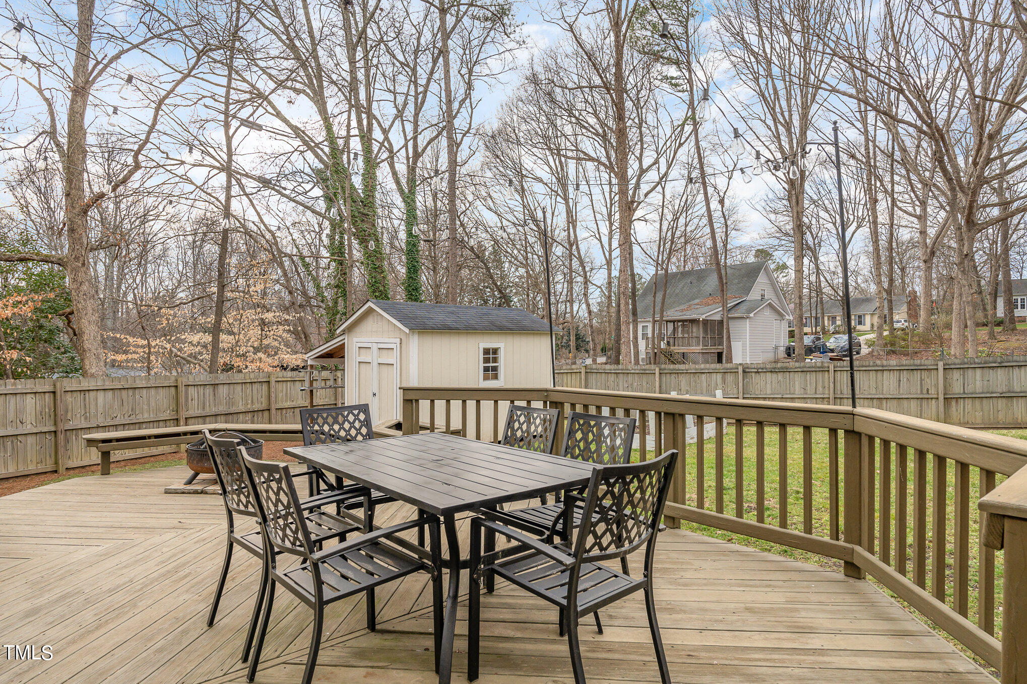 7301 Old Hundred Road Raleigh, NC 27613 - Photo 16 of 17 a view of a roof deck with table and chairs under an umbrella