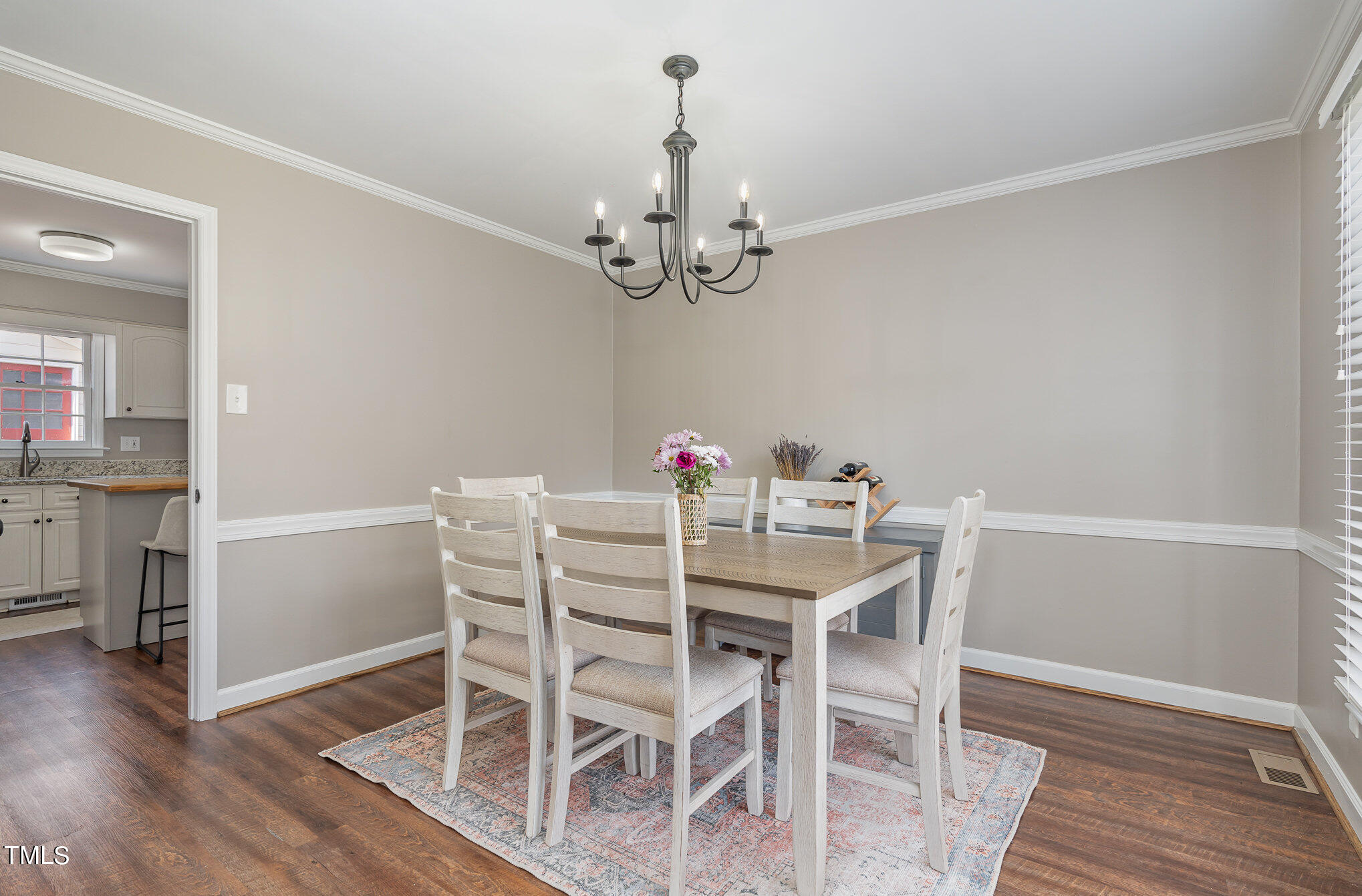 7301 Old Hundred Road Raleigh, NC 27613 - Photo 4 of 17 a view of a dining room with furniture wooden floor and chandelier