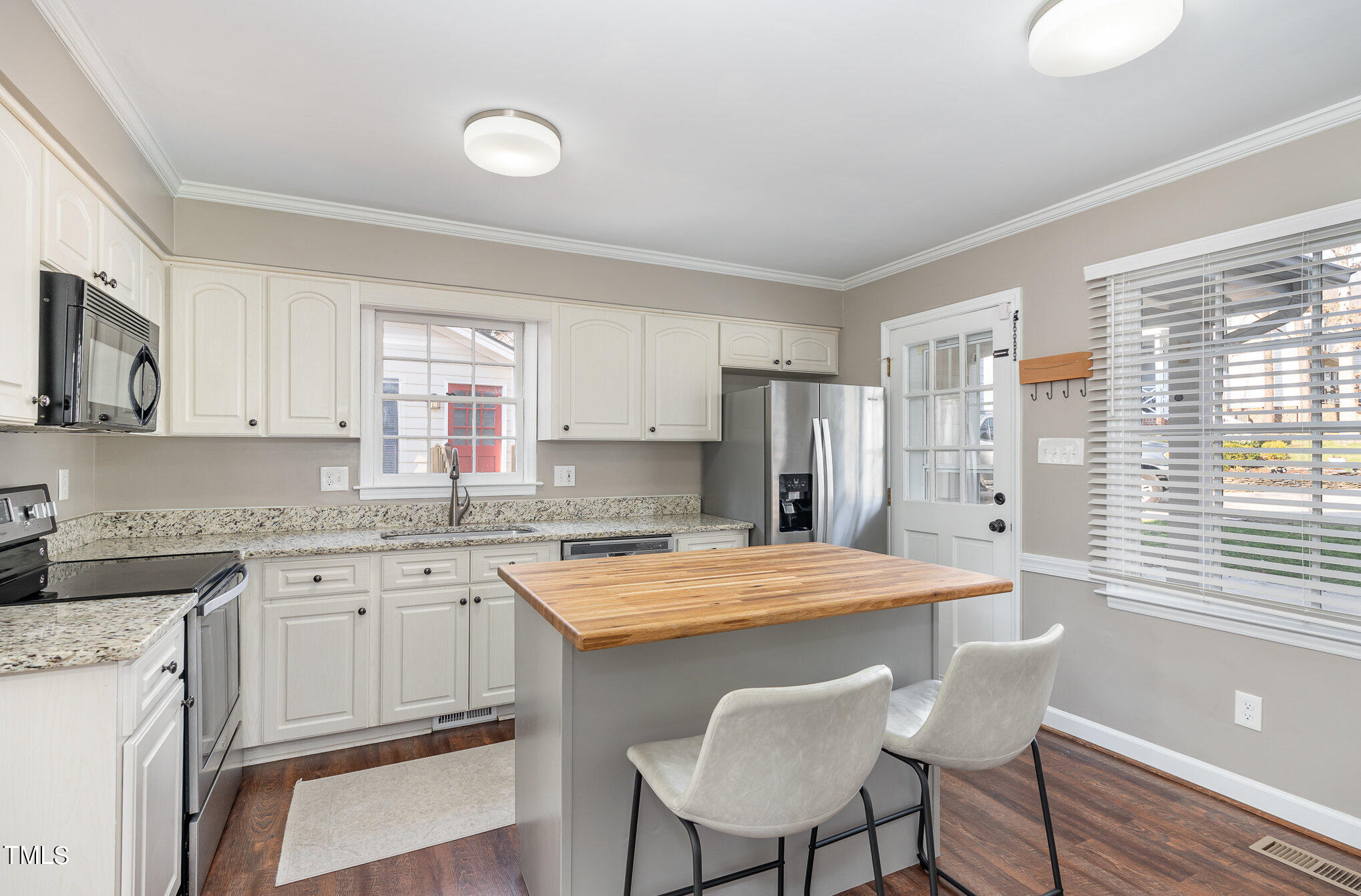 7301 Old Hundred Road Raleigh, NC 27613 - Photo 6 of 17 a kitchen with a stove a sink and a refrigerator