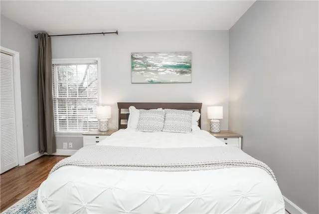 a large bed sitting in a bedroom next to a window