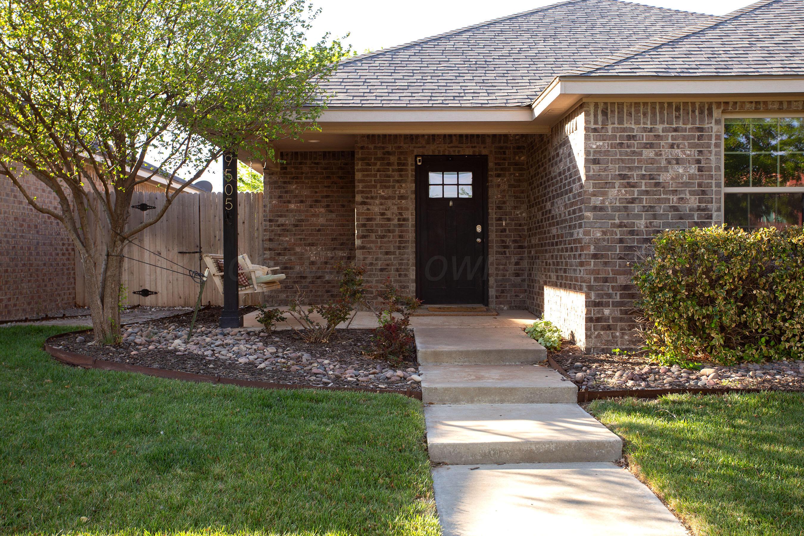 9505 Perry Avenue Amarillo, TX 79119 - Photo 1 of 21 a front view of a house with a garden
