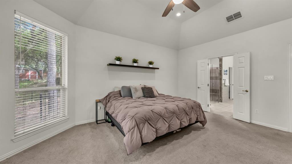 203 Mockingbird Lane Aledo, TX 76008 - Photo 23 of 37 Vaulted ceiling bedroom with carpet flooring