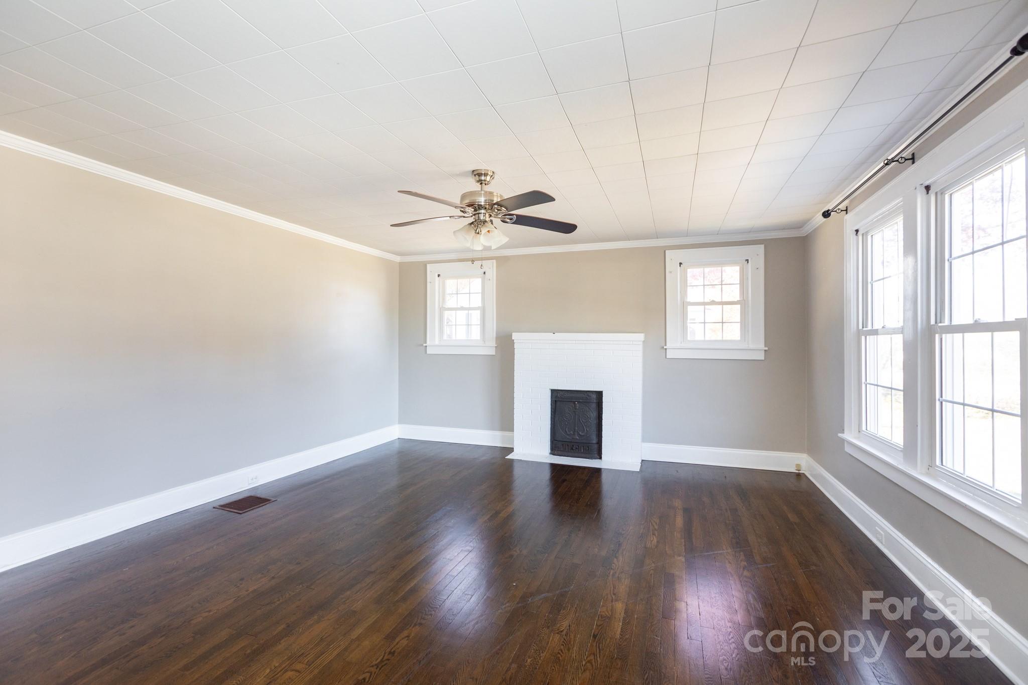 1402 Brantley Road Kannapolis, NC 28083 - Photo 11 of 24 a view of empty room with wooden floor and fan
