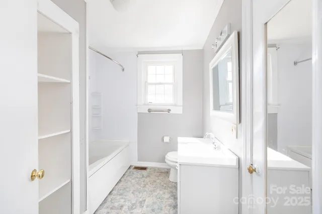 a bathroom with a tub sink and mirror