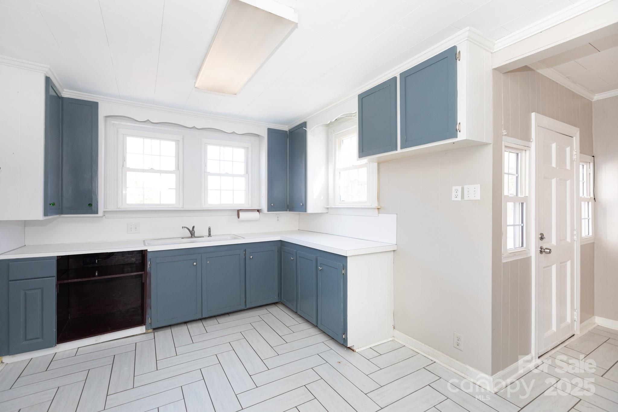 1402 Brantley Road Kannapolis, NC 28083 - Photo 7 of 24 a large kitchen with a sink and dishwasher with white cabinets