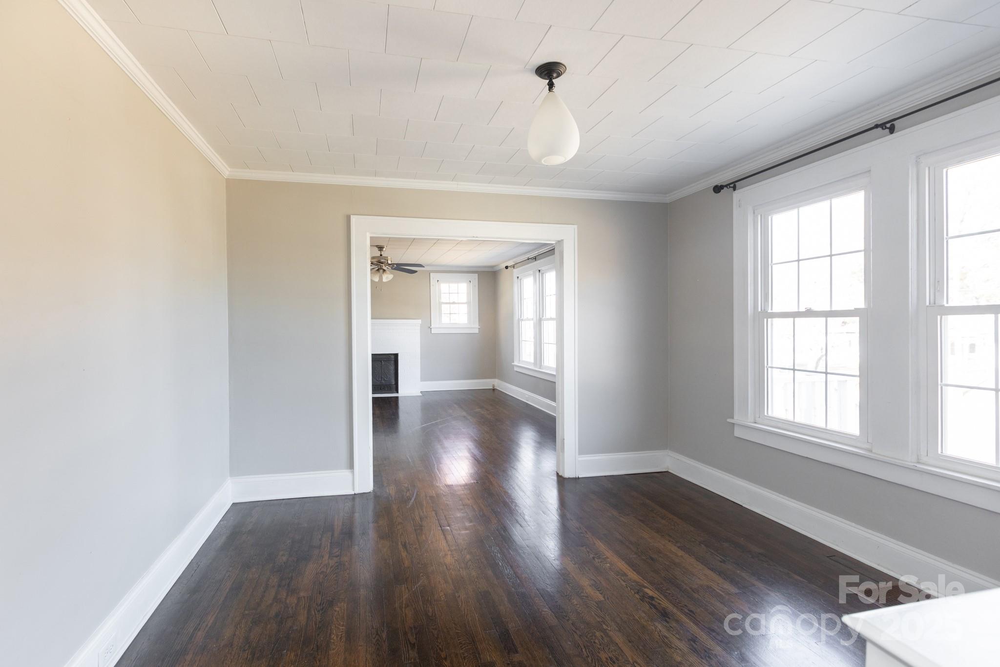 1402 Brantley Road Kannapolis, NC 28083 - Photo 7 of 27 an empty room with wooden floor and windows