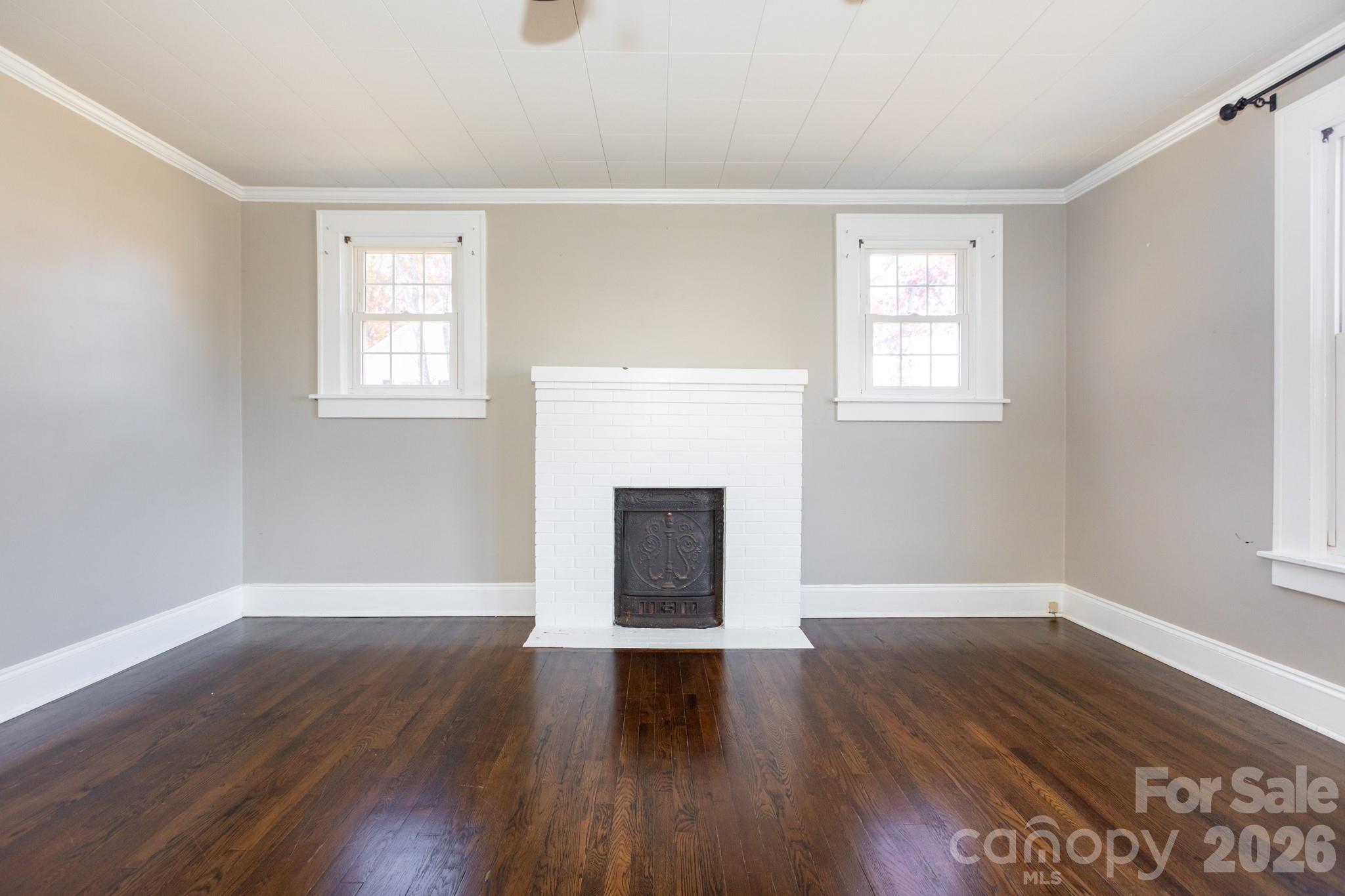 1402 Brantley Road Kannapolis, NC 28083 - Photo 7 of 29 a view of an empty room with wooden floor and a window