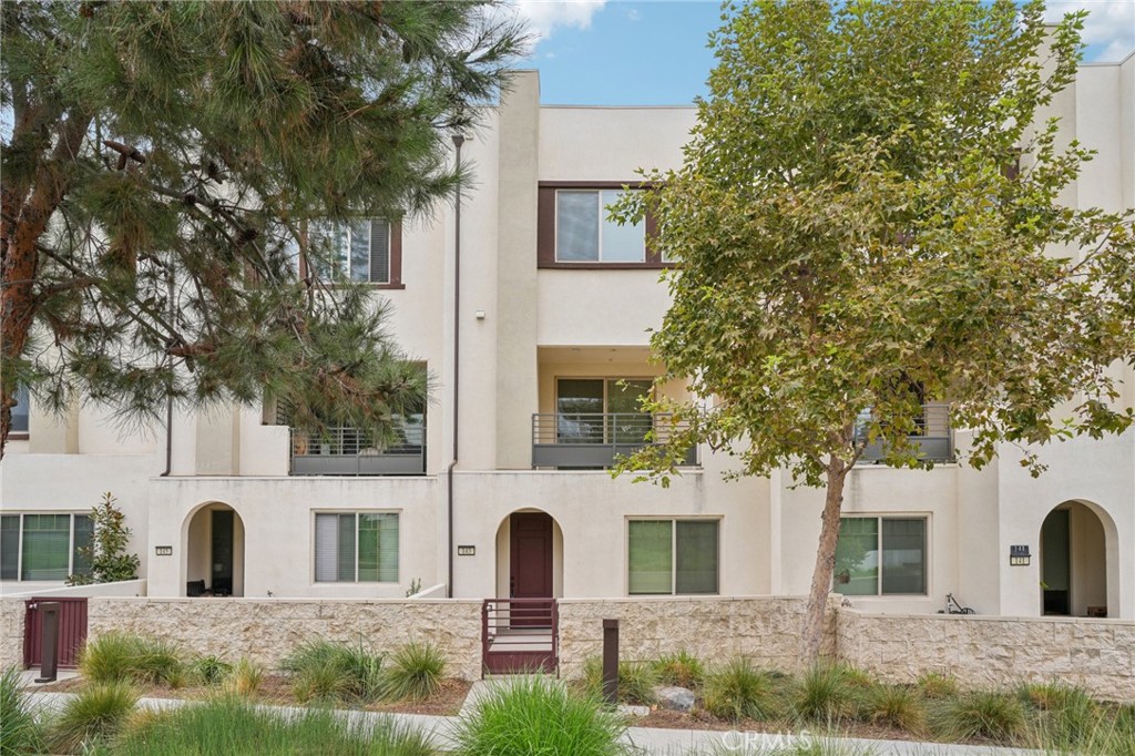 143 Frame Irvine, CA 92618 - Photo 1 of 41 a view of a white house with large windows and a tree