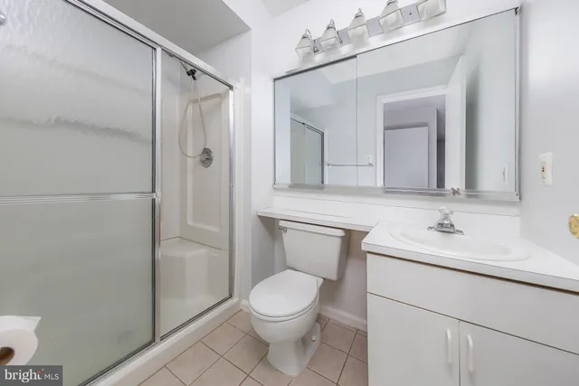 a bathroom with a toilet a sink and a mirror