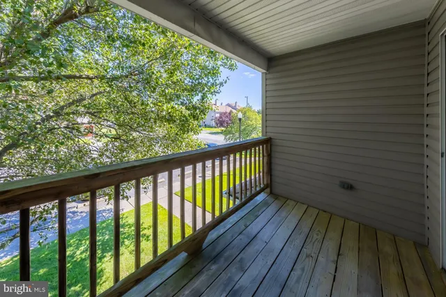 a view of a balcony with wooden floor