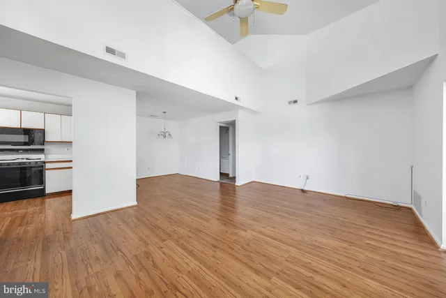 a view of empty room with wooden floor