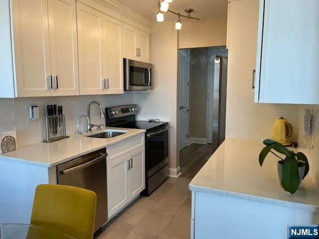 a view of a workspace with furniture and a bathroom