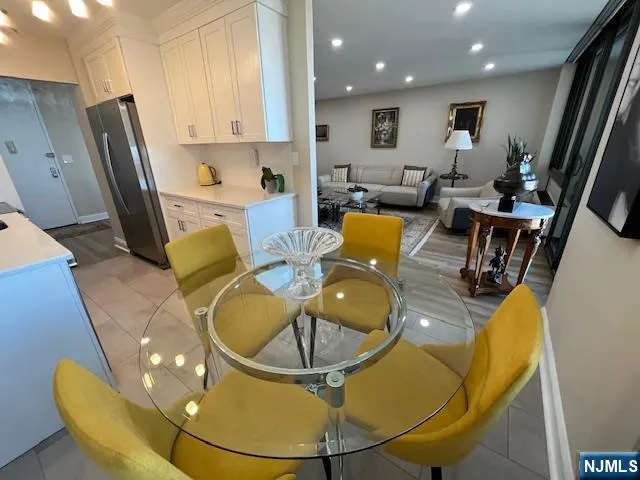 a view of a dining room with furniture and a floor to ceiling window