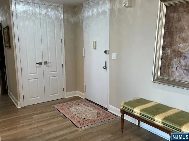 a bedroom with a bed and a flat tv screen on dresser