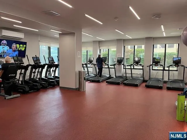 a living room with stainless steel appliances furniture a refrigerator and a dining table