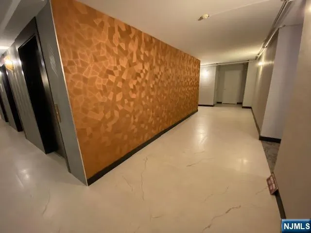 a kitchen with cabinets and refrigerator