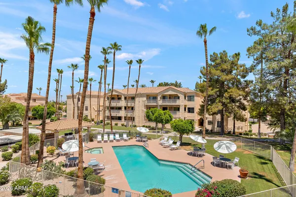 a front view of a house with yard patio and swimming pool