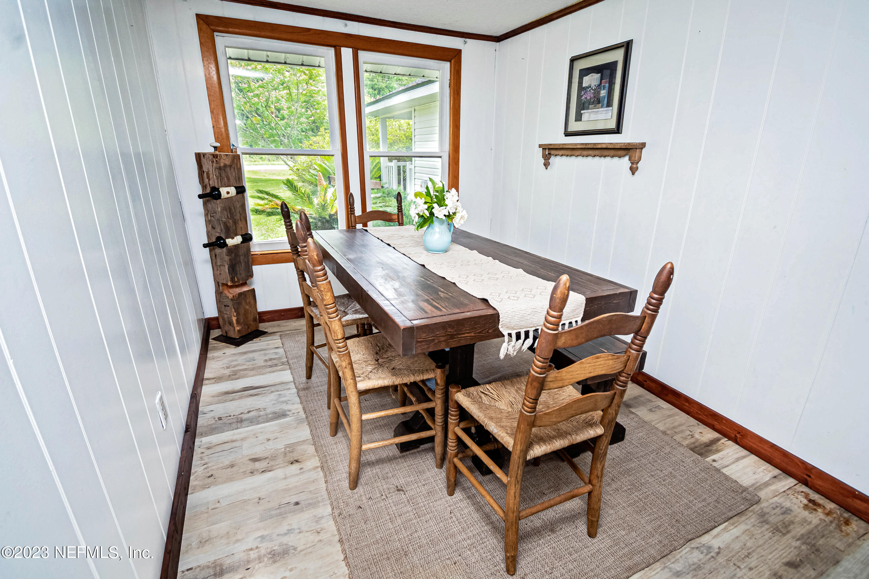 8619 Mud Lake Road Macclenny, FL 32063 - Photo 14 of 49 a dining room with a wooden table and chairs