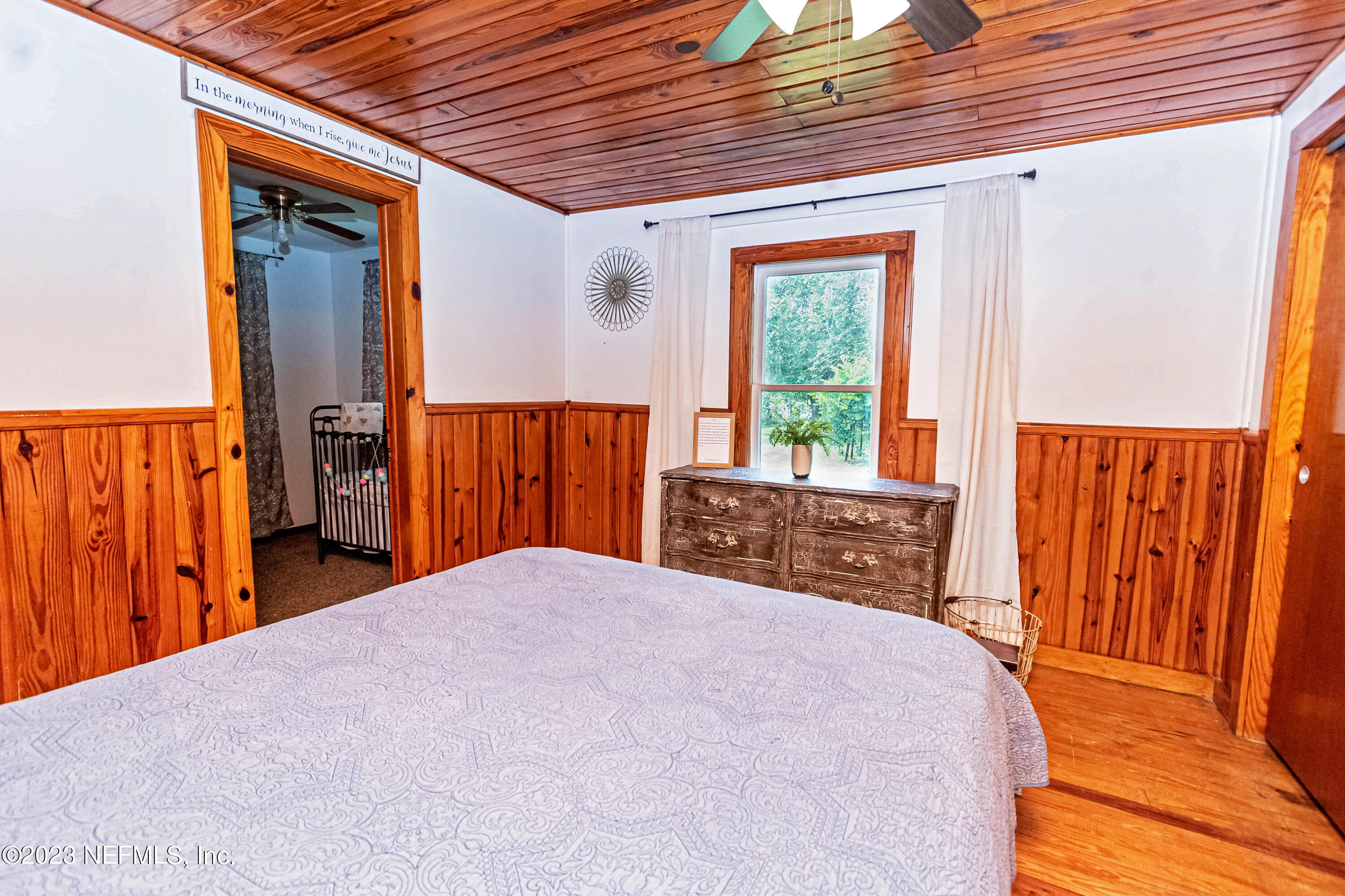 8619 Mud Lake Road Macclenny, FL 32063 - Photo 15 of 49 a bedroom with a bed and wooden floor