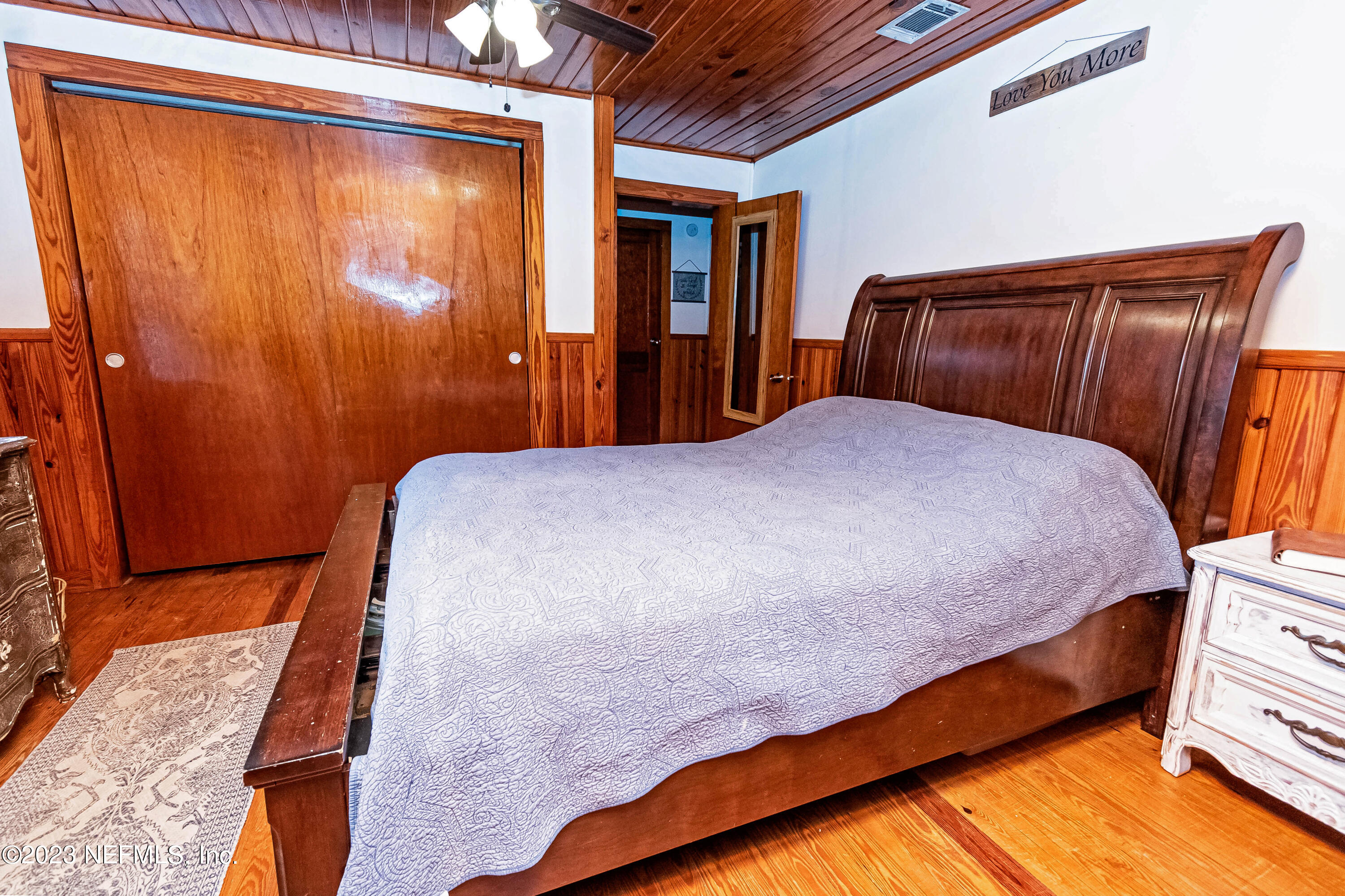 8619 Mud Lake Road Macclenny, FL 32063 - Photo 16 of 49 a bedroom with a bed and wooden floor