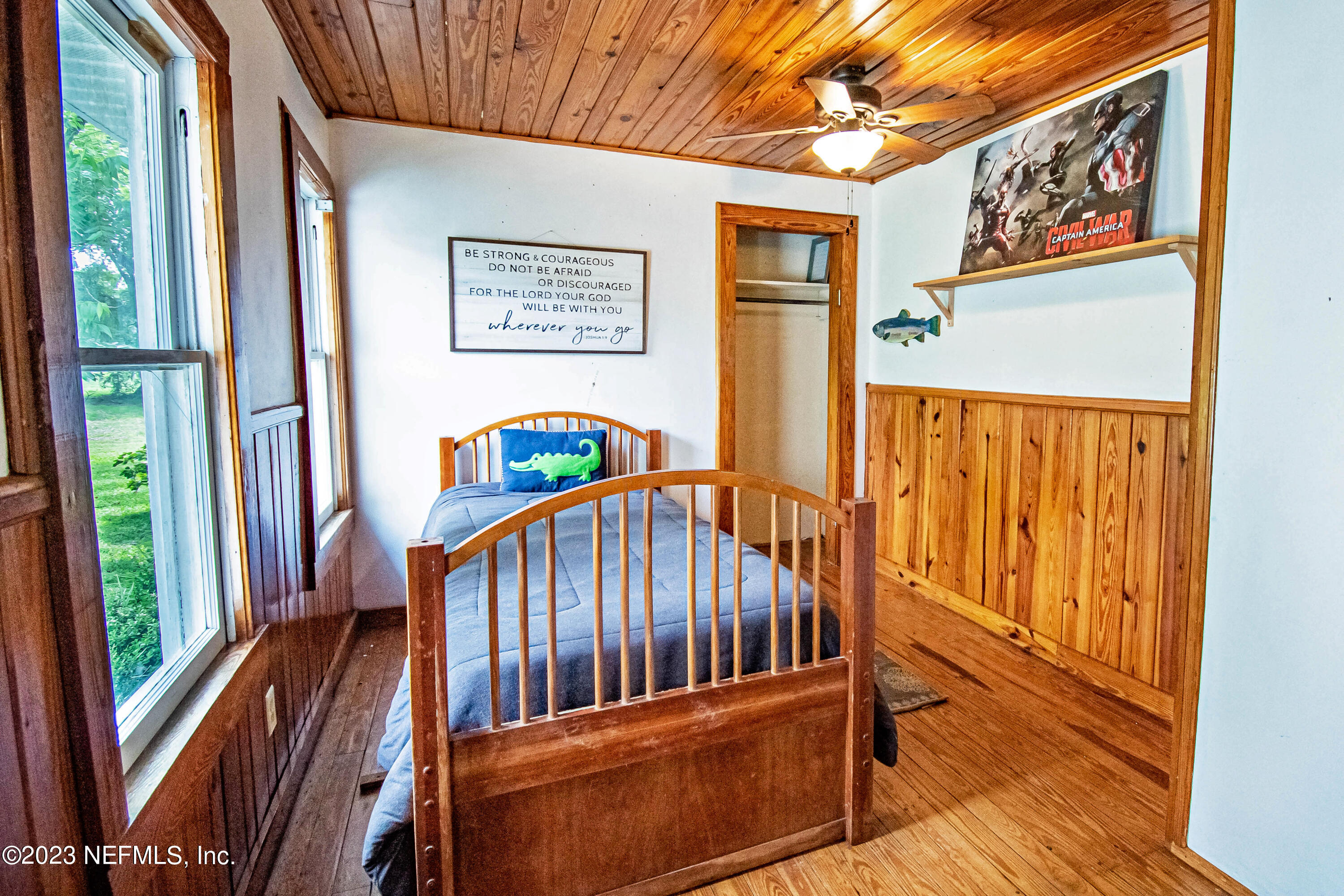8619 Mud Lake Road Macclenny, FL 32063 - Photo 20 of 49 a view of staircase with lots of frames on wall and a large window