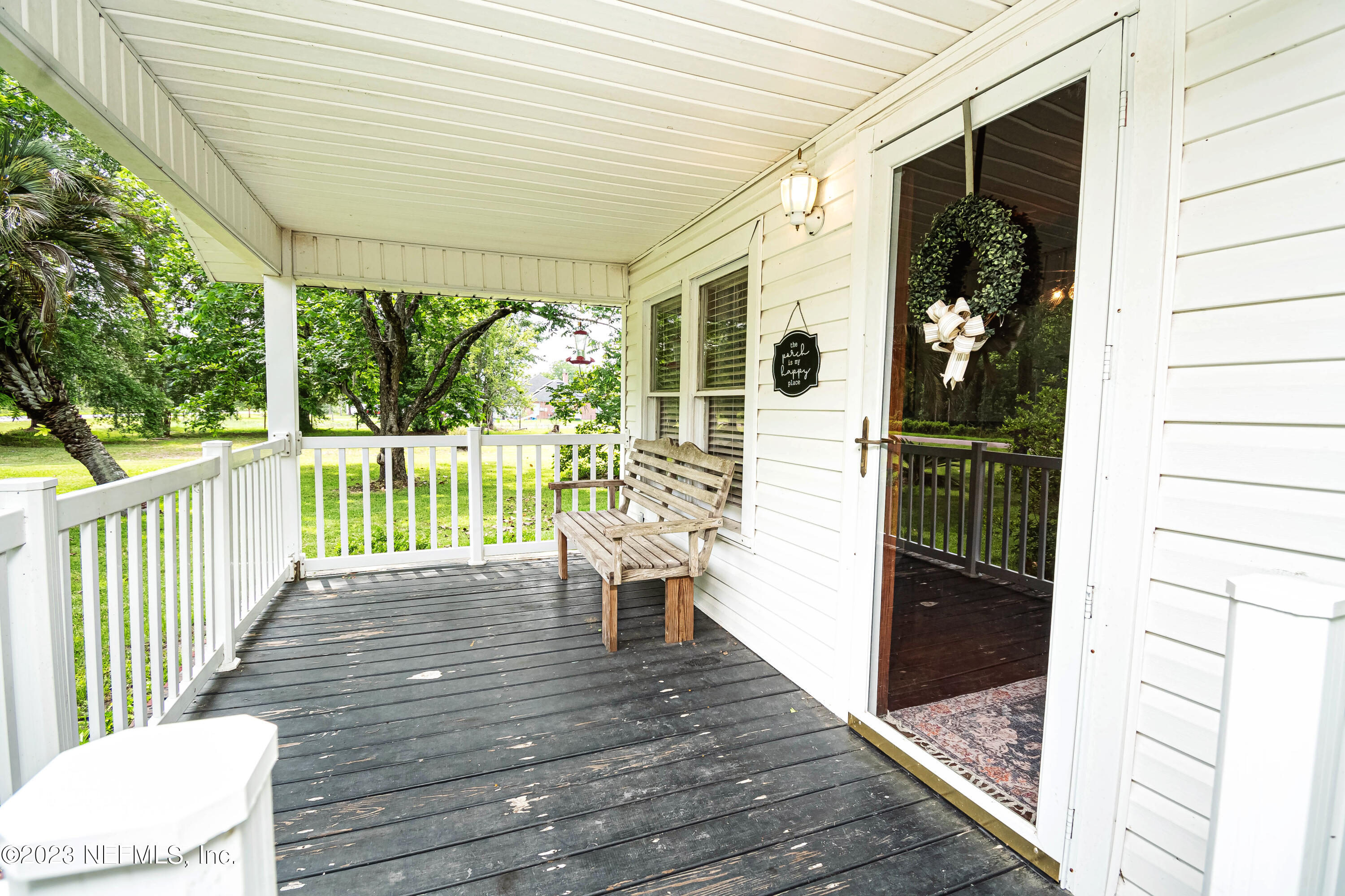 8619 Mud Lake Road Macclenny, FL 32063 - Photo 2 of 49 a view of a porch with wooden floor and furniture