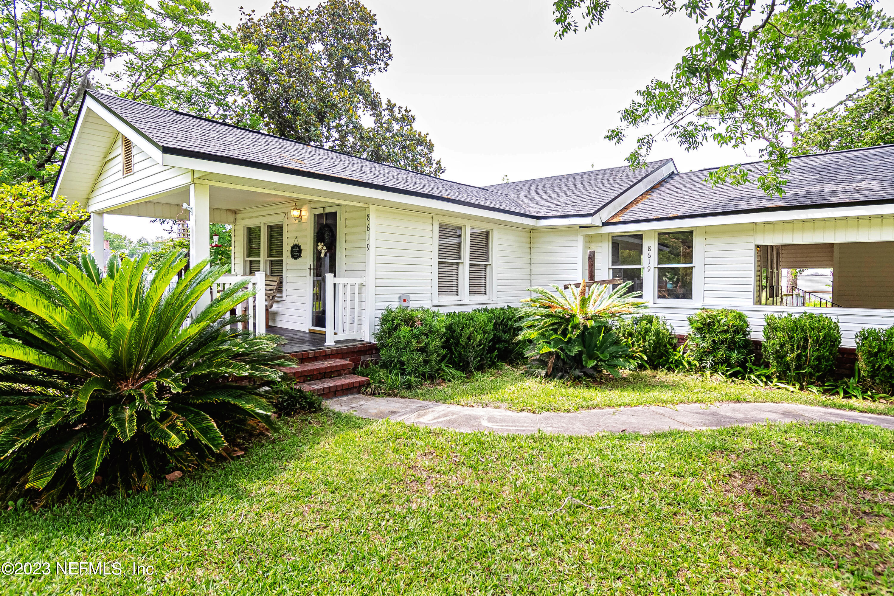 8619 Mud Lake Road Macclenny, FL 32063 - Photo 25 of 49 a front view of a house with a yard