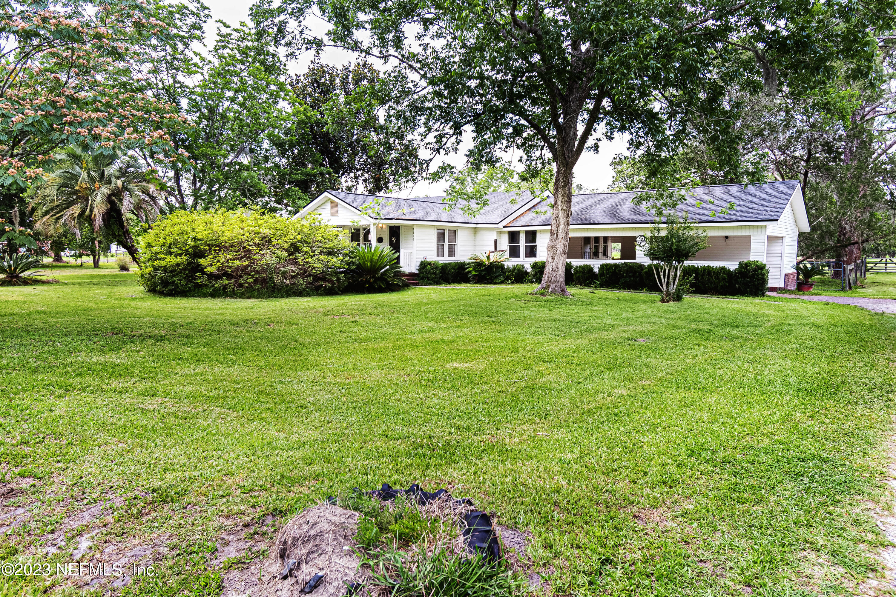 8619 Mud Lake Road Macclenny, FL 32063 - Photo 30 of 49 a front view of a house with a garden
