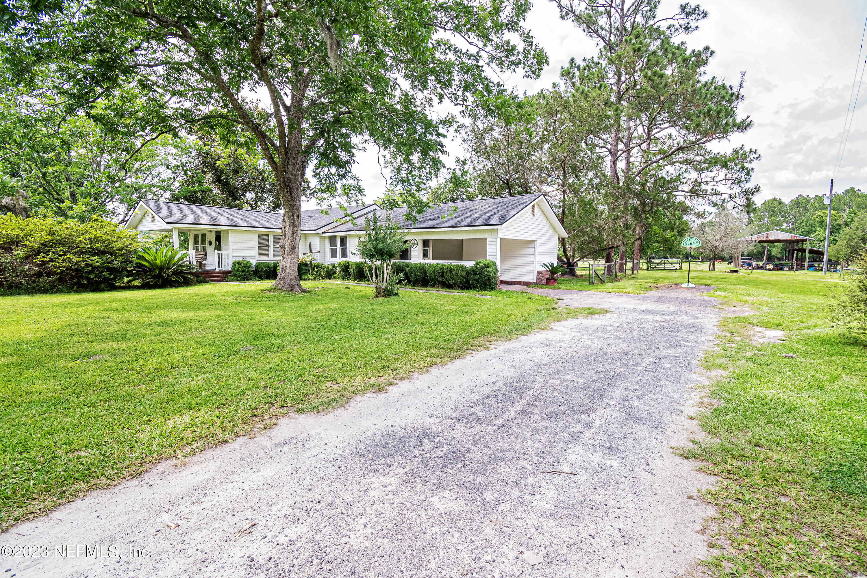 8619 Mud Lake Road Macclenny, FL 32063 - Photo 38 of 49 a front view of a house with a yard and trees