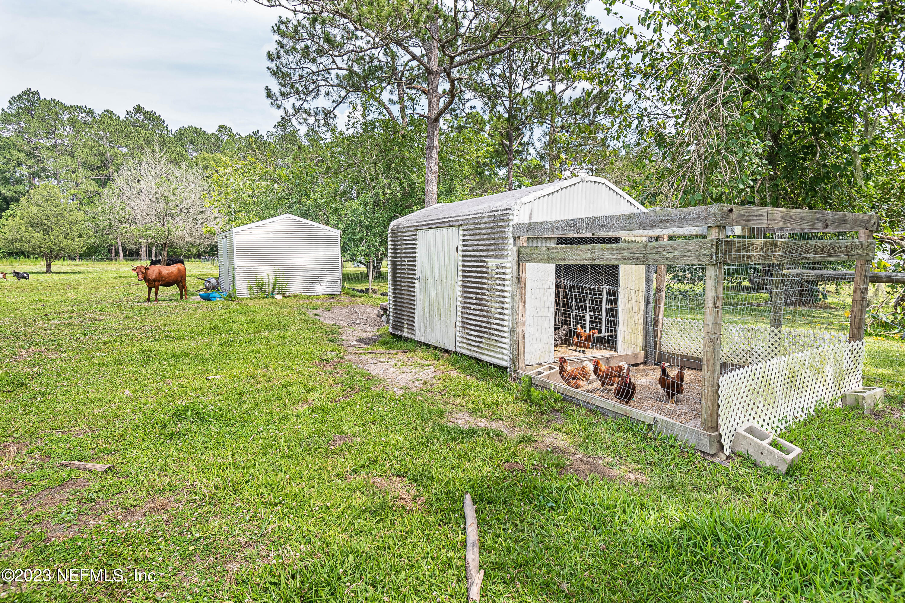 8619 Mud Lake Road Macclenny, FL 32063 - Photo 40 of 49 a backyard of a house with table and chairs