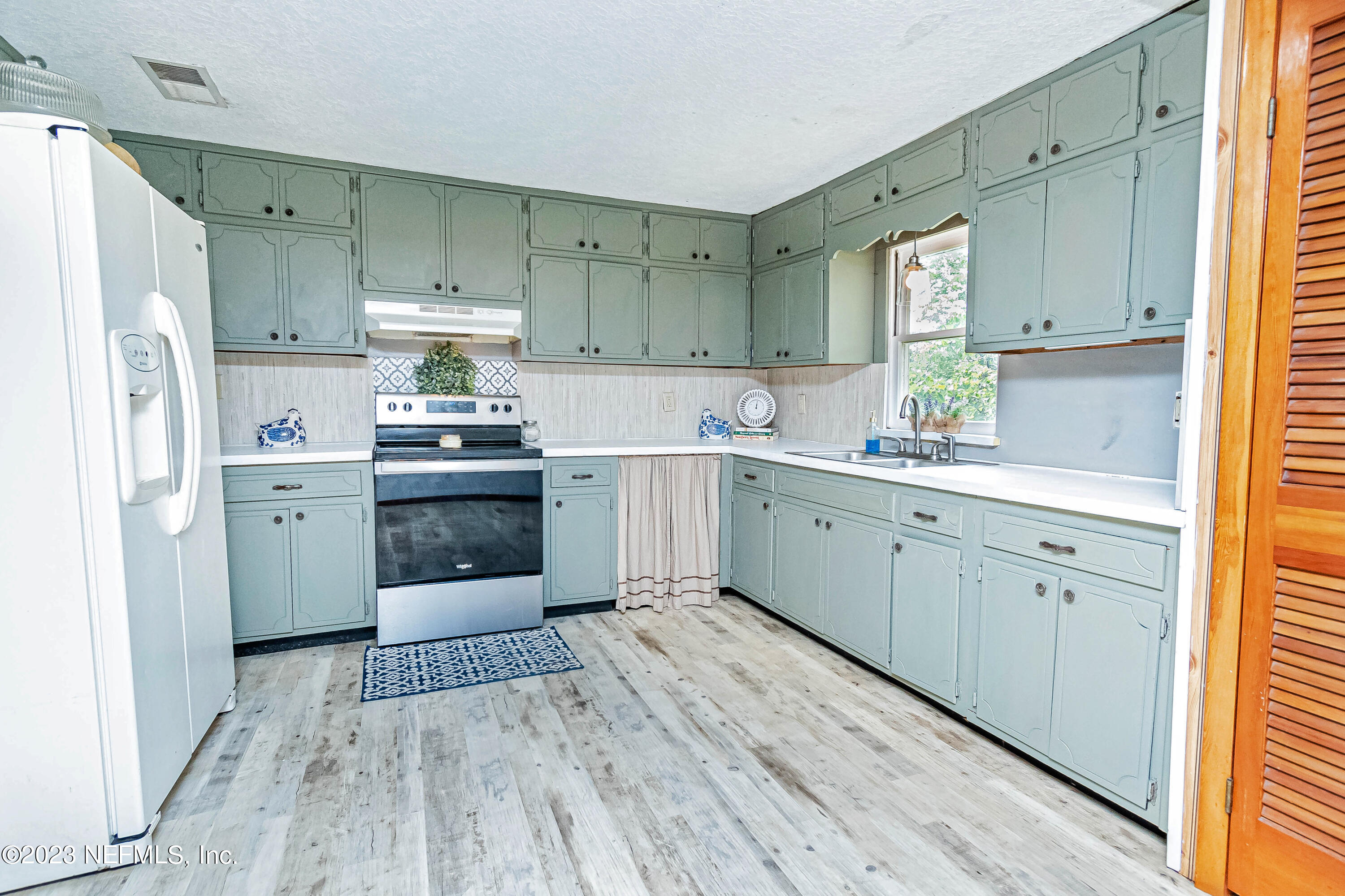 8619 Mud Lake Road Macclenny, FL 32063 - Photo 9 of 49 a kitchen with white cabinets appliances and sink