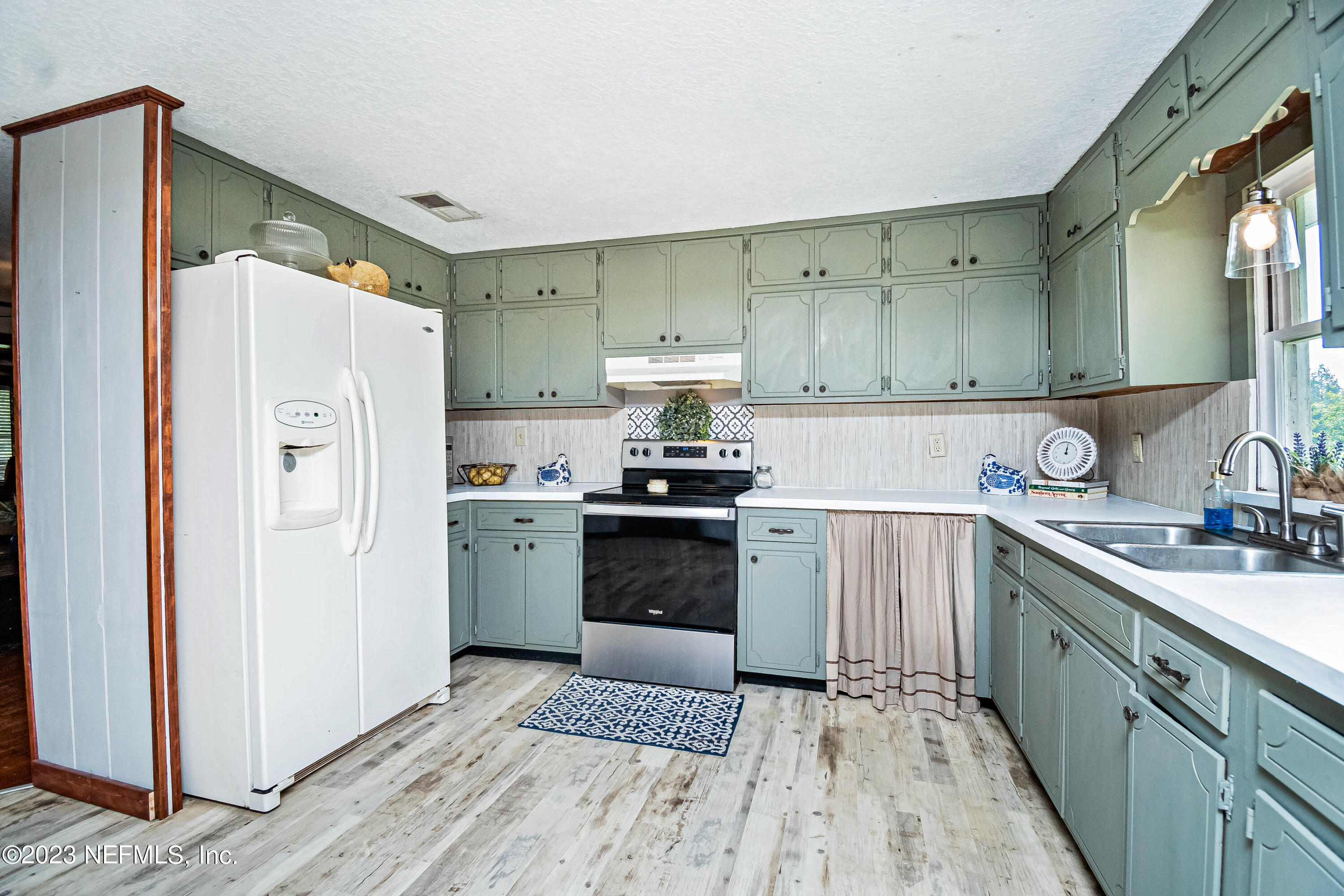 8619 Mud Lake Road Macclenny, FL 32063 - Photo 10 of 49 a kitchen with a sink a stove and refrigerator