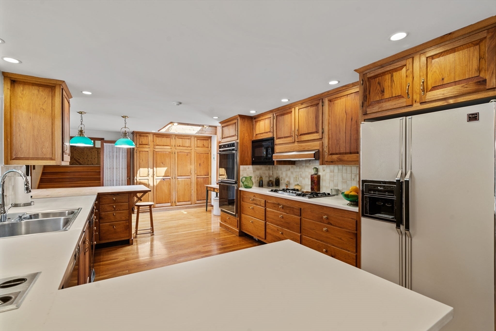 3 Summit Groton, MA 01450 - Photo 14 of 38 a kitchen with stainless steel appliances kitchen island granite countertop a refrigerator a stove and a sink dishwasher with wooden floor