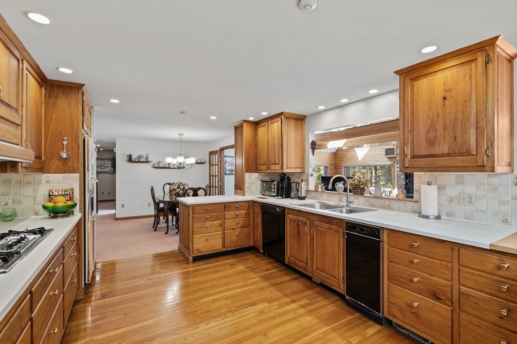 3 Summit Groton, MA 01450 - Photo 16 of 38 a large kitchen with stainless steel appliances granite countertop a large stove top oven a sink dishwasher and cabinets with wooden floor