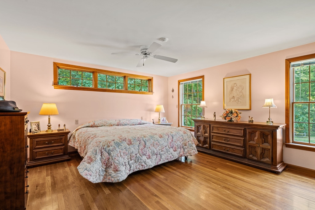 3 Summit Groton, MA 01450 - Photo 30 of 38 a bedroom with a bed and wooden floor