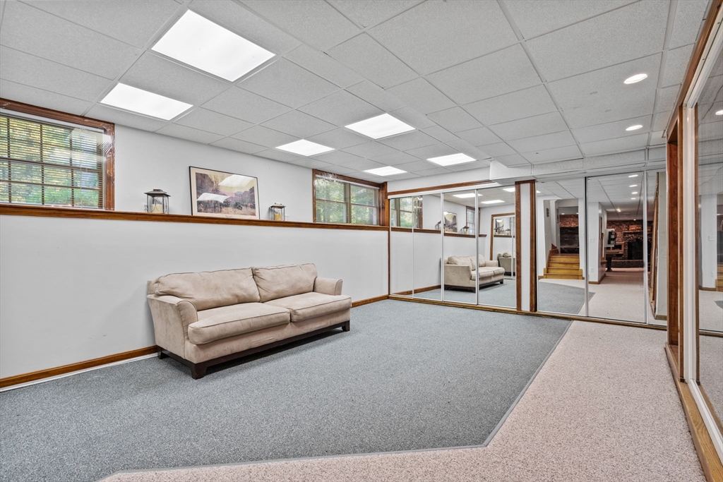 3 Summit Groton, MA 01450 - Photo 36 of 38 a living room with furniture and a large window