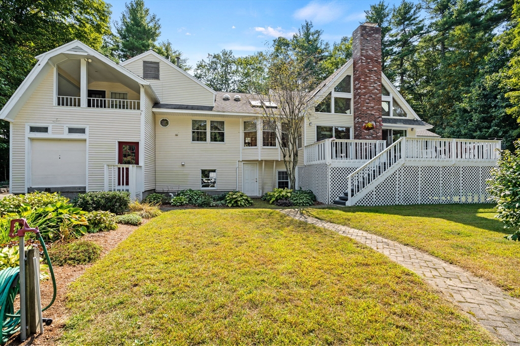 3 Summit Groton, MA 01450 - Photo 7 of 38 a front view of a house with a yard and garage