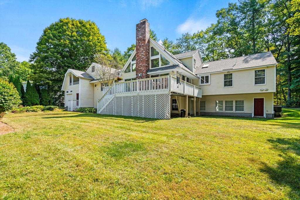 3 Summit Groton, MA 01450 - Photo 8 of 38 a front view of a house with a garden
