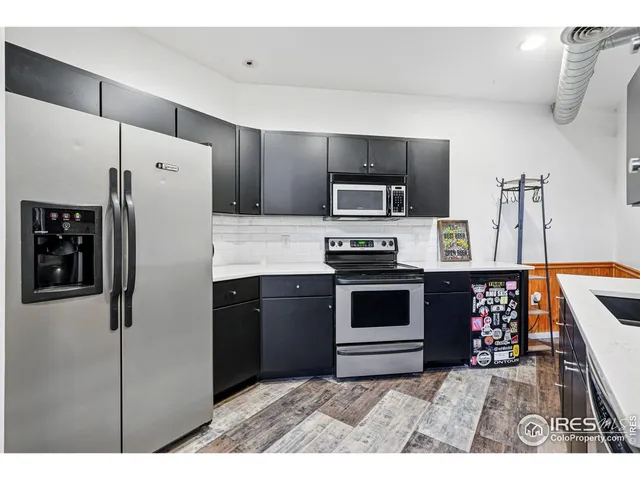 a kitchen with stainless steel appliances a refrigerator sink and stove