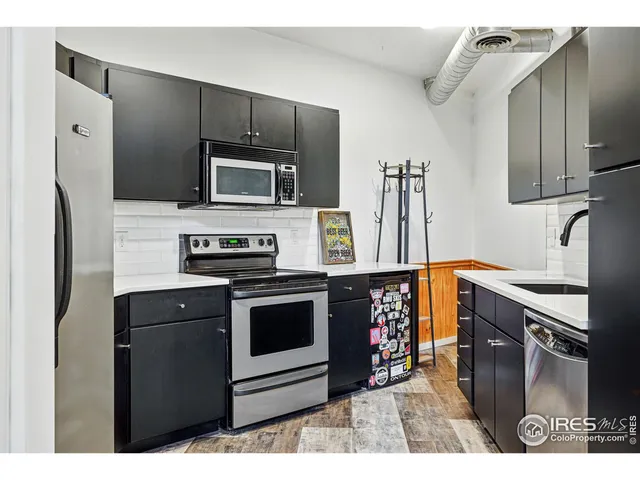 a kitchen with stainless steel appliances granite countertop a stove microwave and refrigerator