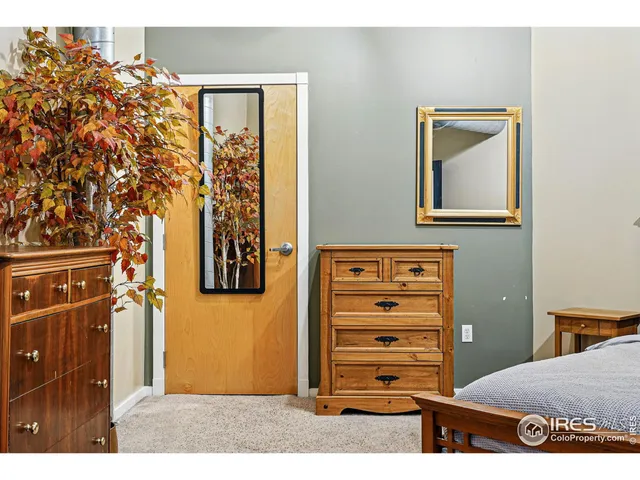 a view of a bedroom with a bed and a dresser