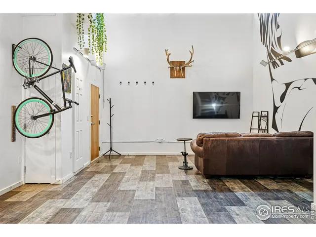 a living room with a couch and a stove with wooden floor