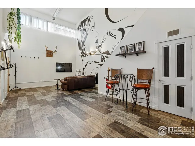 a view of a livingroom with furniture and a flat screen tv