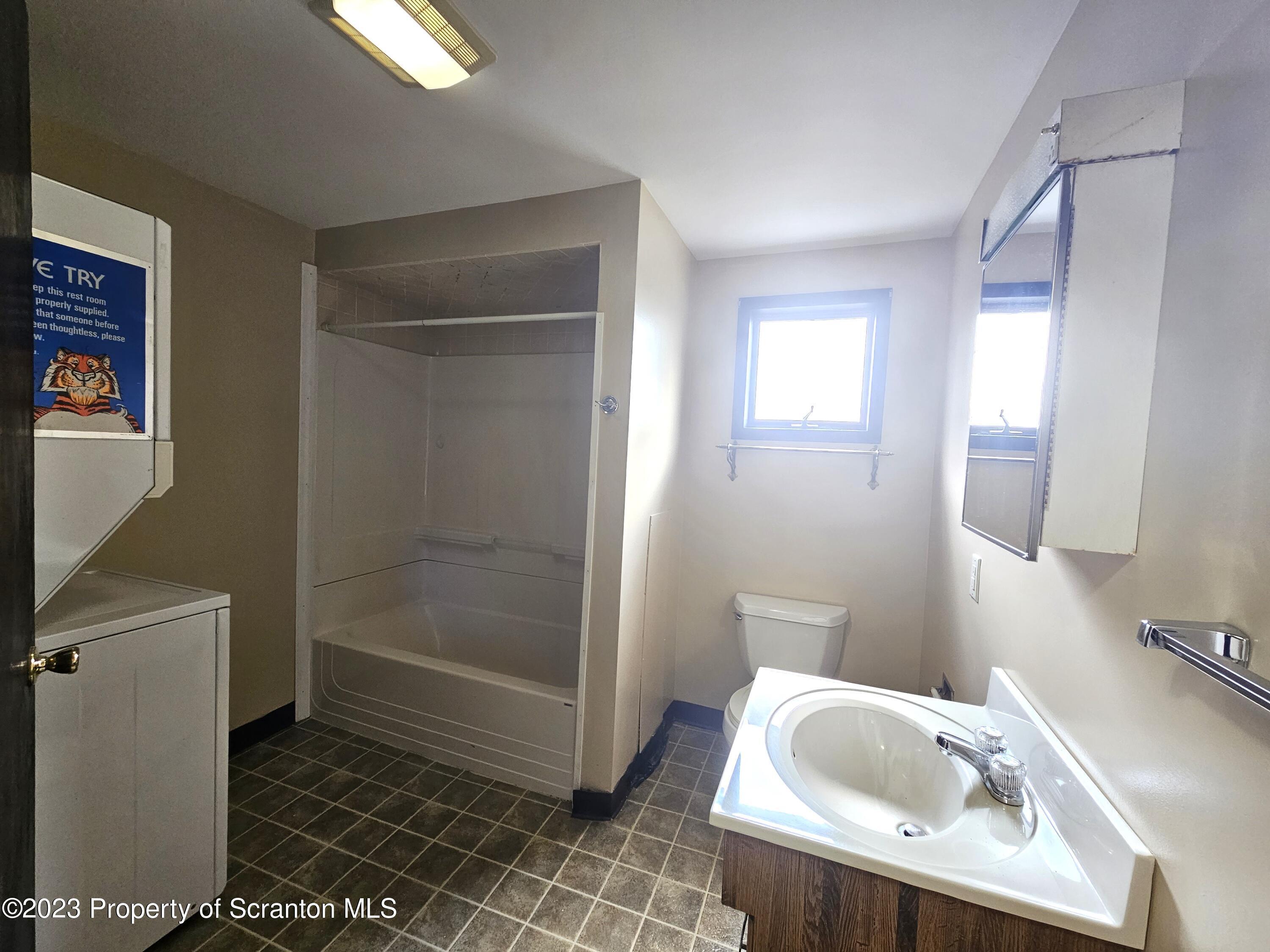 526 Hughes Court Scranton, PA 18504 - Photo 5 of 8 a bathroom with a sink a toilet and shower