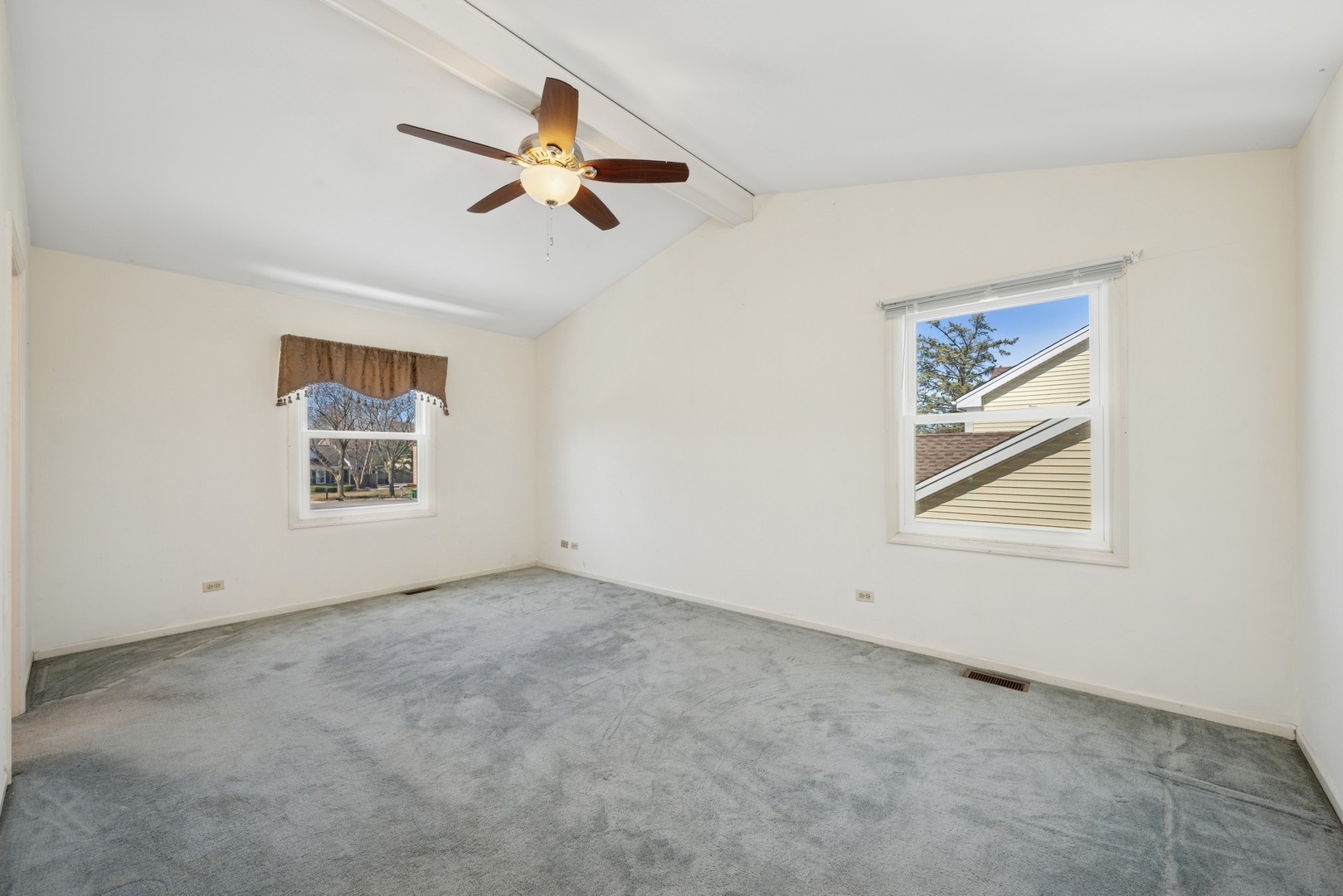 1005 Honeysuckle Drive Wheeling, IL 60090 - Photo 11 of 25 an empty room with a window and a ceiling fan