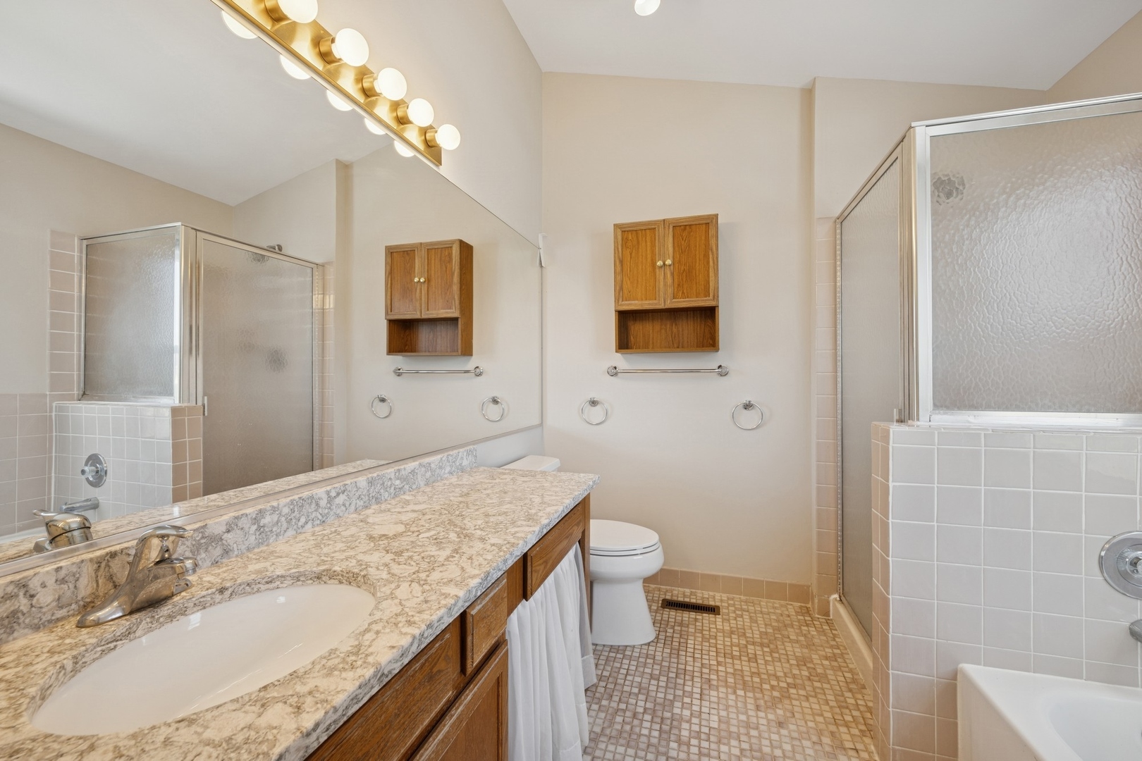 1005 Honeysuckle Drive Wheeling, IL 60090 - Photo 12 of 25 a bathroom with a granite countertop sink toilet and shower