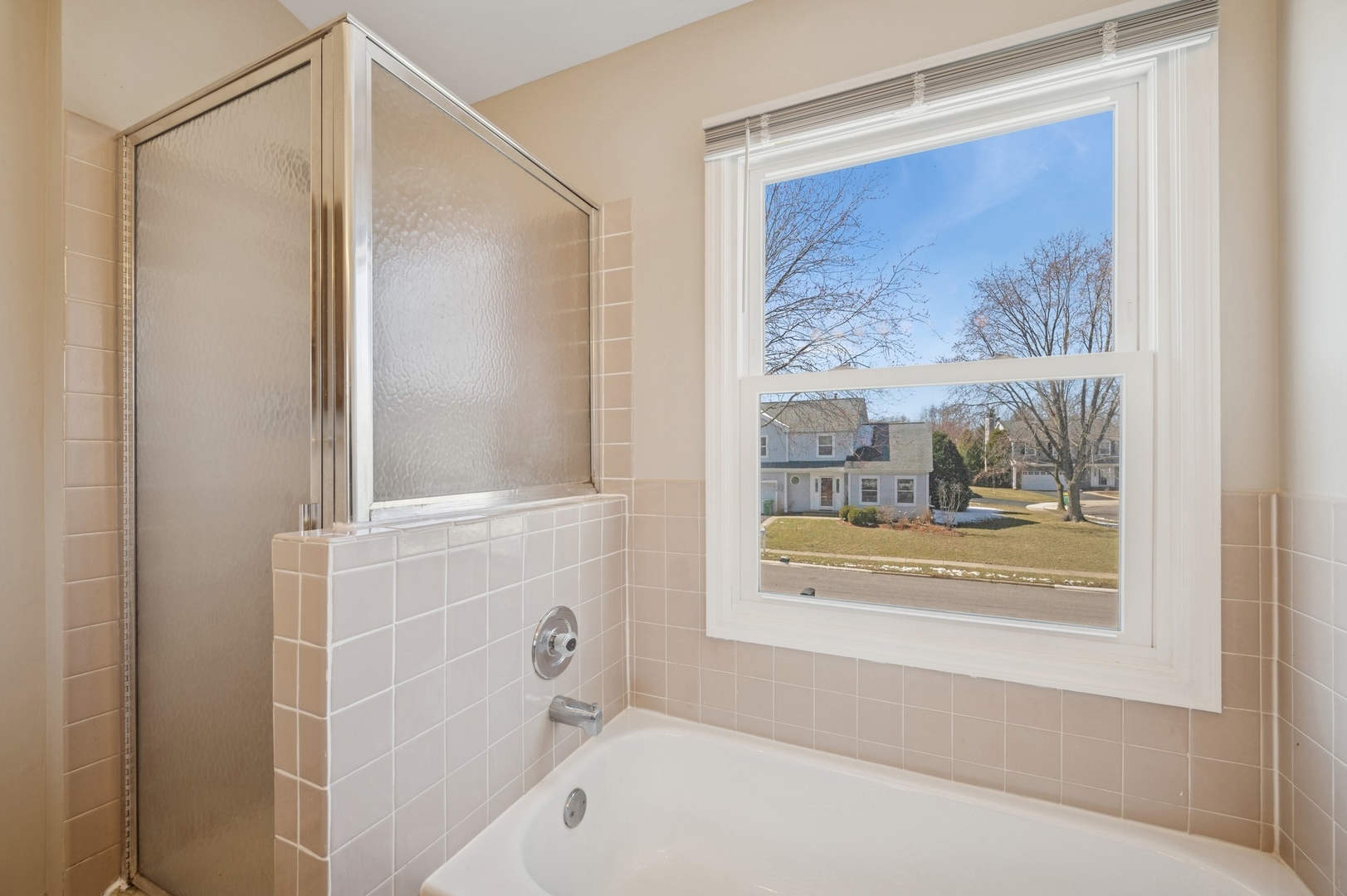 1005 Honeysuckle Drive Wheeling, IL 60090 - Photo 13 of 25 a bathroom with a bathtub and a shower
