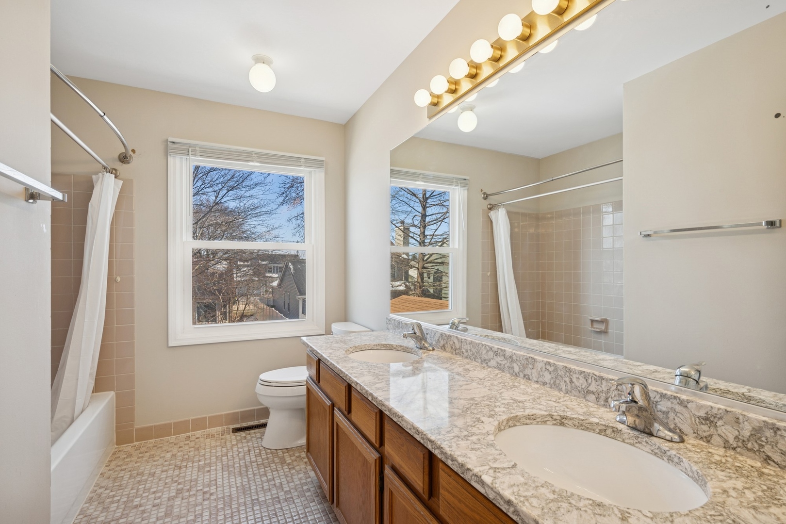 1005 Honeysuckle Drive Wheeling, IL 60090 - Photo 16 of 25 a bathroom with a granite countertop sink toilet and shower