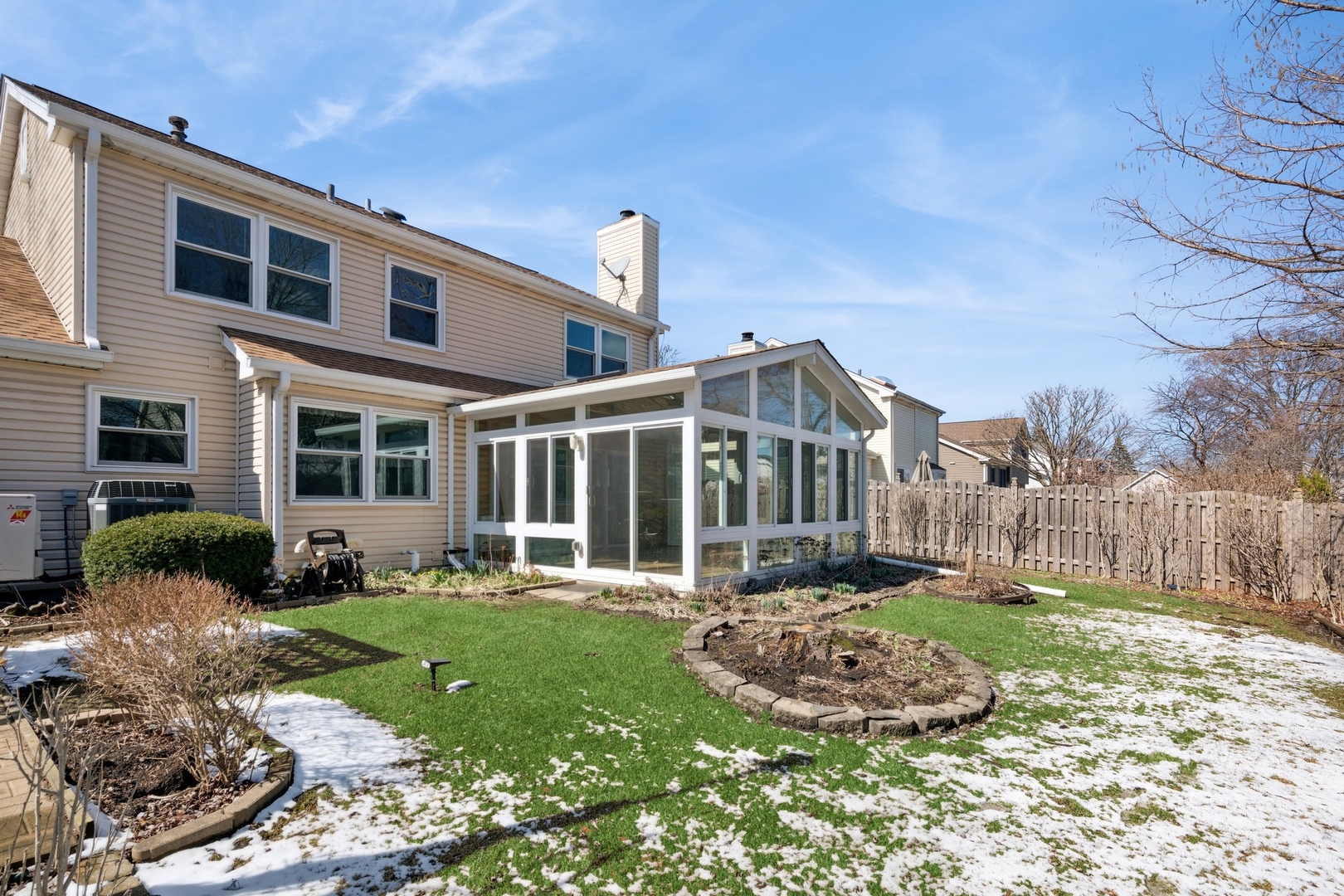 1005 Honeysuckle Drive Wheeling, IL 60090 - Photo 21 of 25 a front view of a house with a yard table and chairs