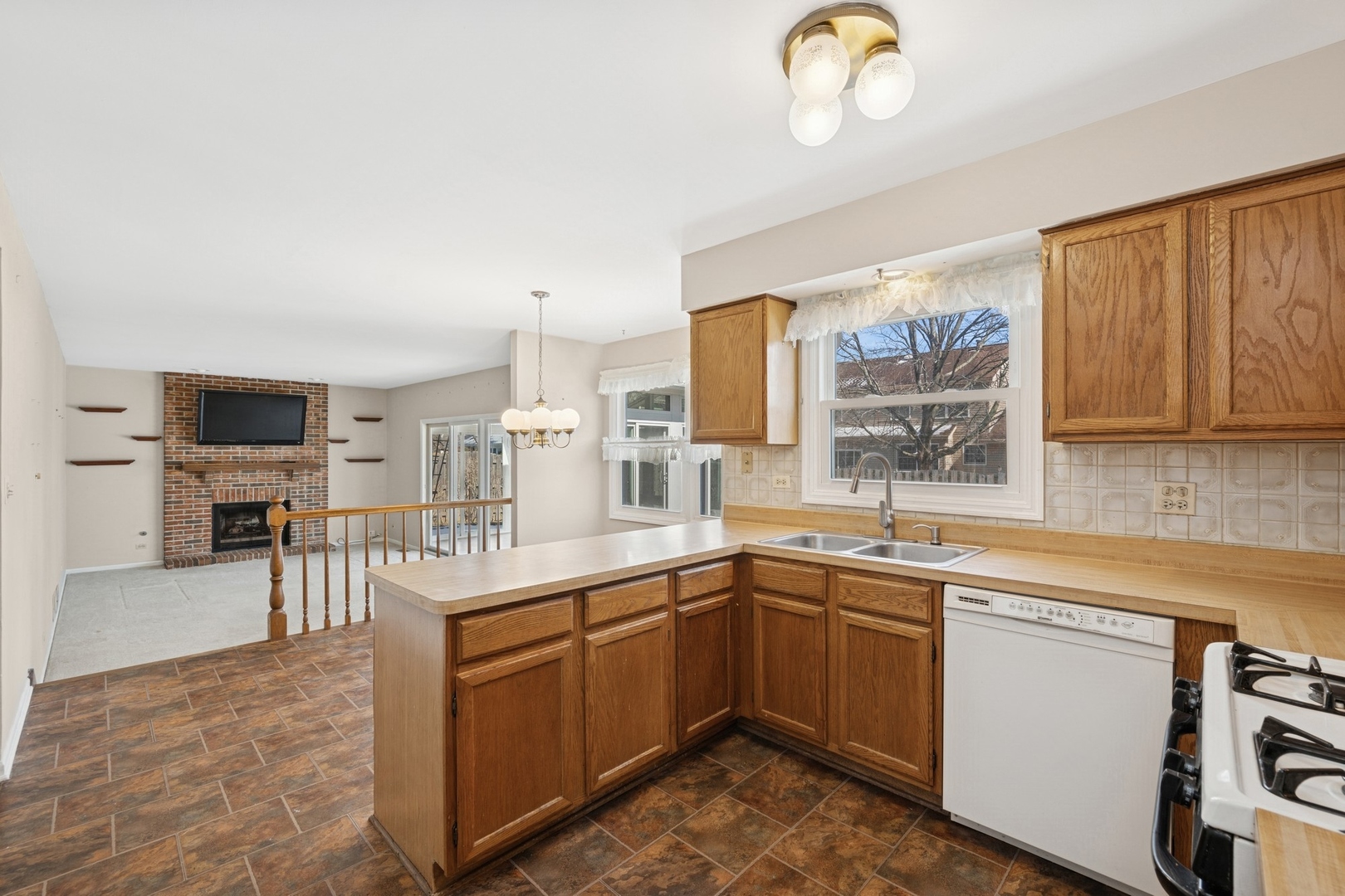 1005 Honeysuckle Drive Wheeling, IL 60090 - Photo 7 of 25 a kitchen with a sink counter top space appliances and cabinets